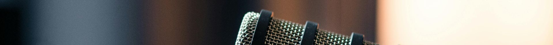 Close-up of a Rode microphone in a studio, emphasizing professional audio equipment.