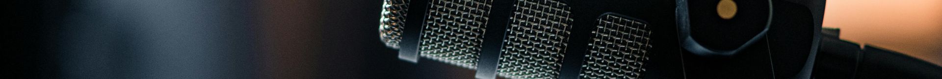 Close-up of a Rode microphone in a studio, emphasizing professional audio equipment.