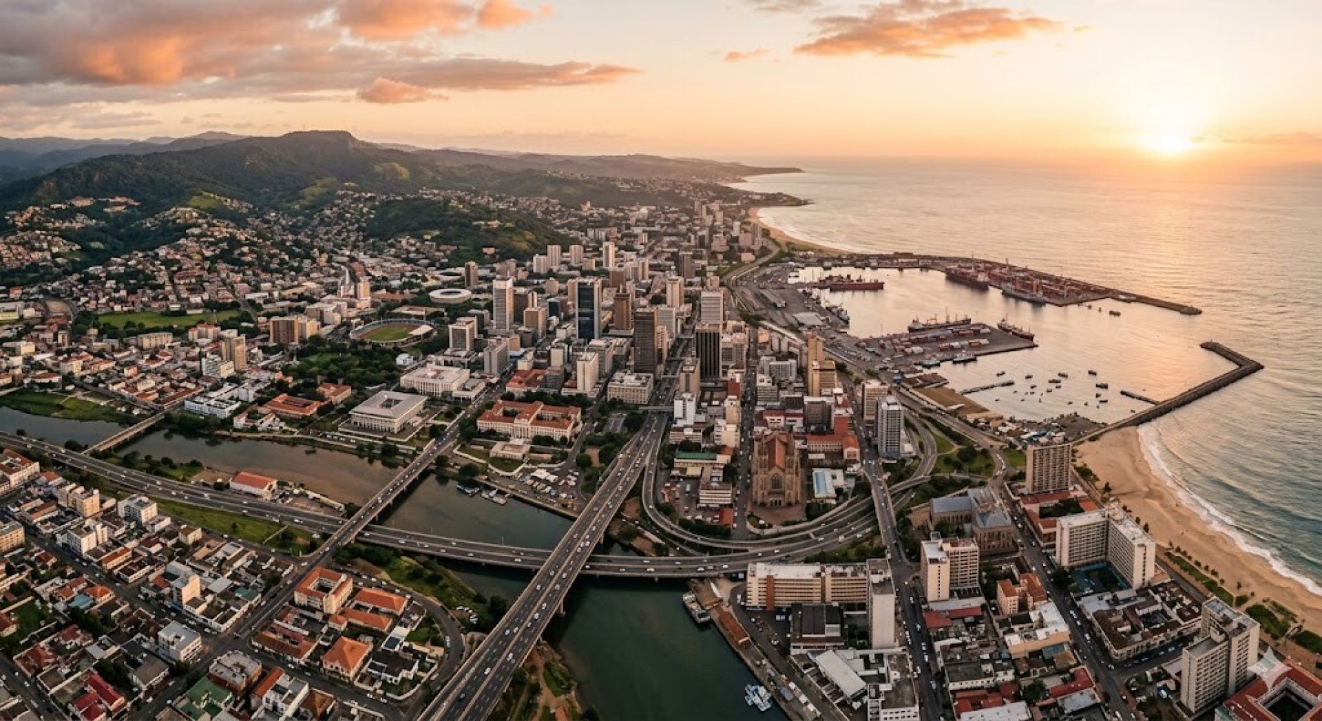 A woman walks down a Monrovian street carrying goods on her head in a vibrant dress.